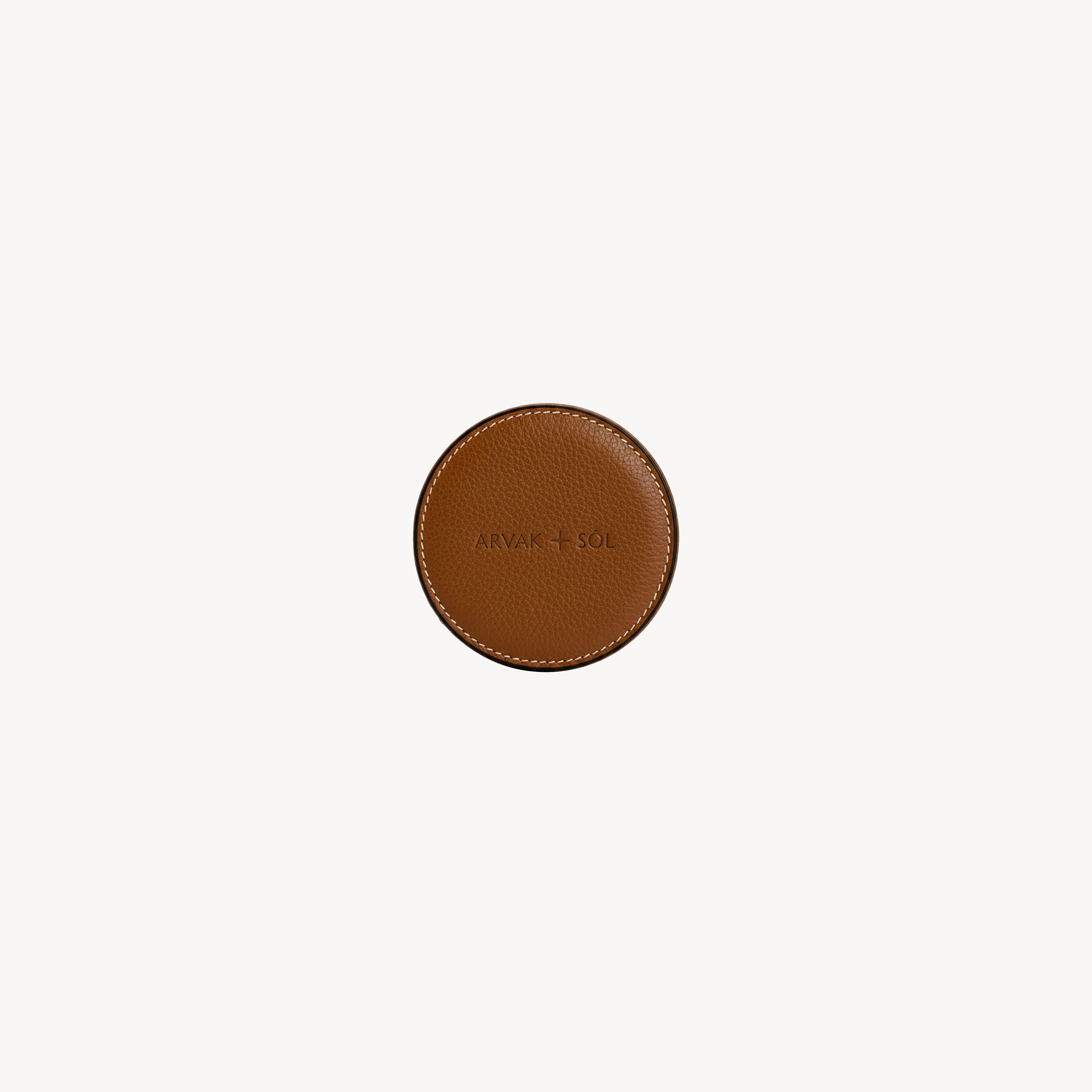 Round waste bag holder by Arvak + Sól in saddle brown, featuring a compact, coin purse-style design with a circular shape.