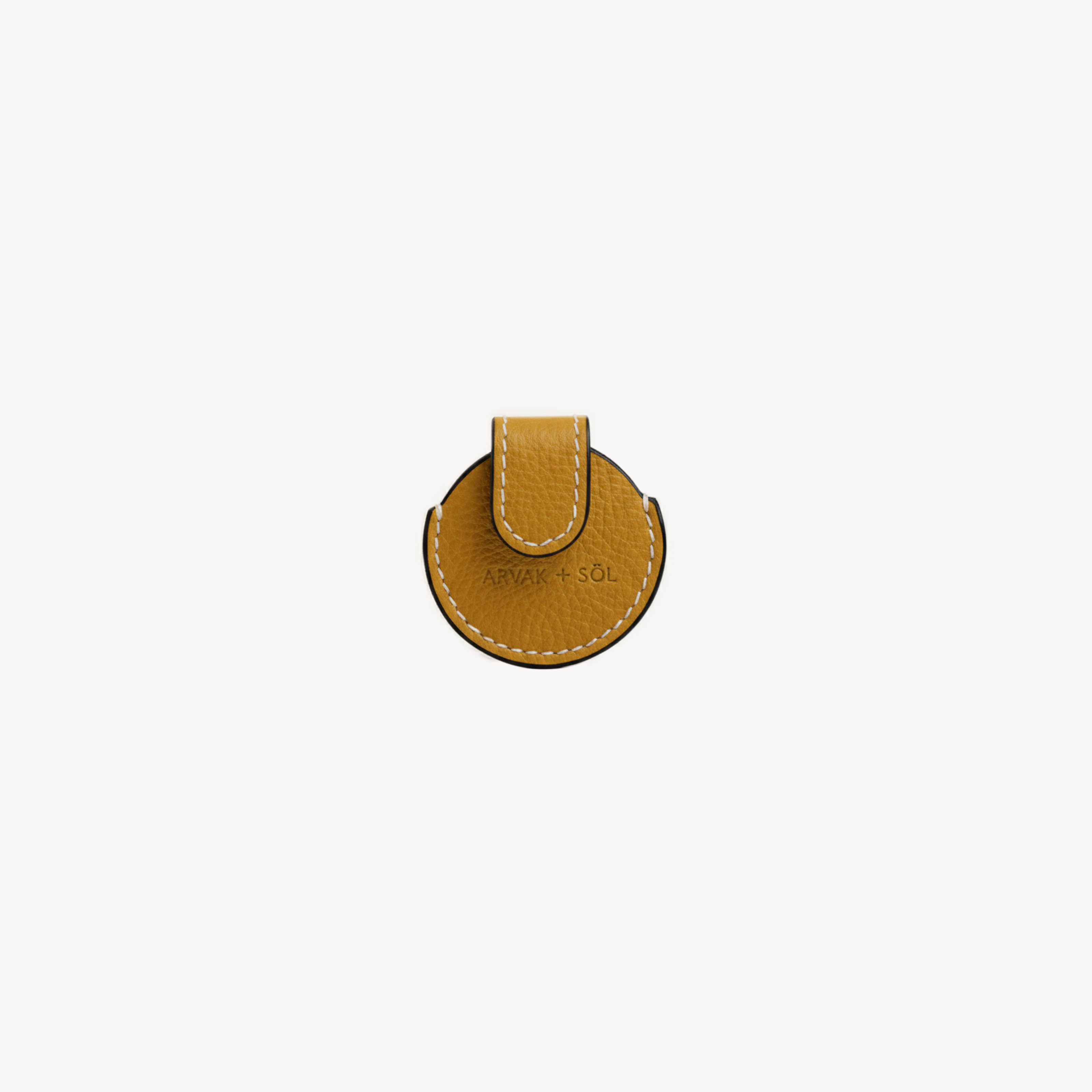 Mustard-colored Arvak + Sól Airtag case with sleek design, showcasing its compact, protective cover for Apple Airtags.