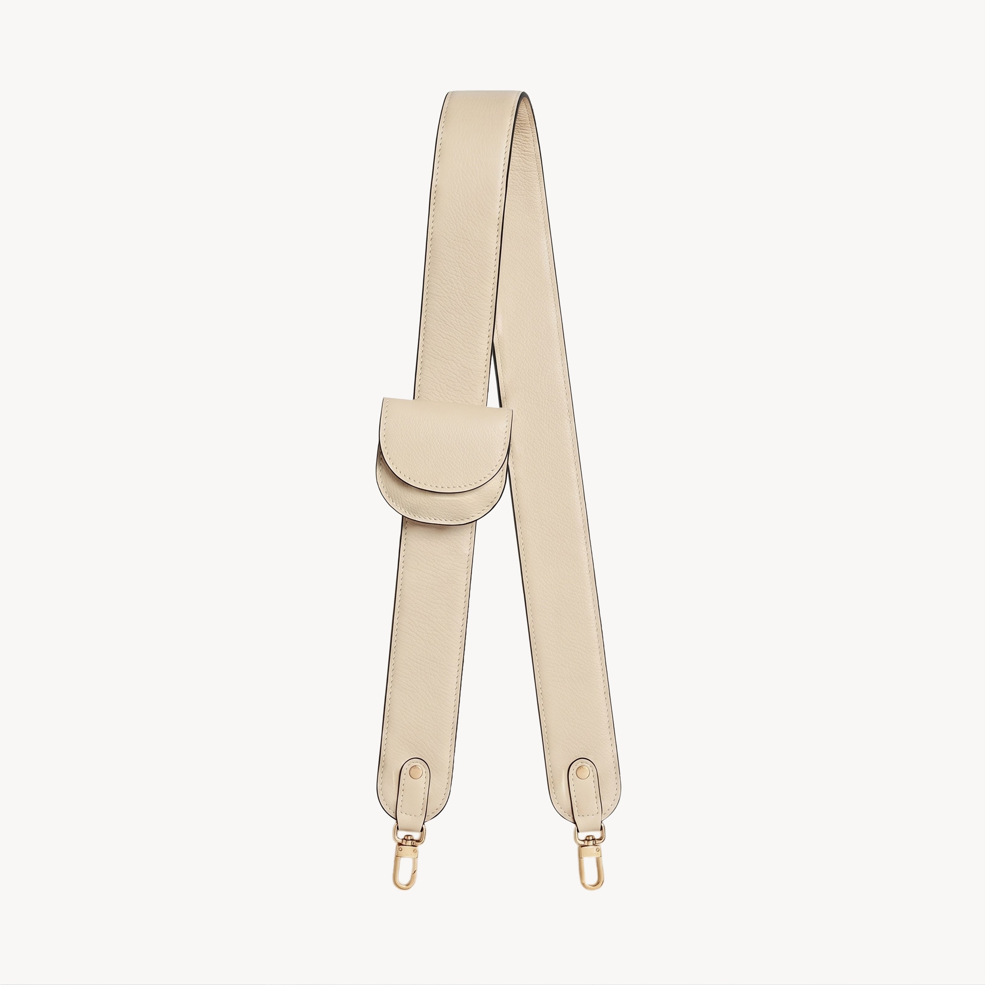 Cream-colored bag strap and folding wallet set by Arvak + Sól, featuring stylish, textured leather accessories.