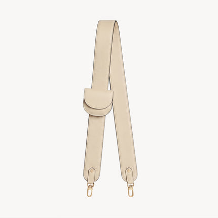 Cream-colored bag strap and folding wallet set by Arvak + Sól, featuring stylish, textured leather accessories.