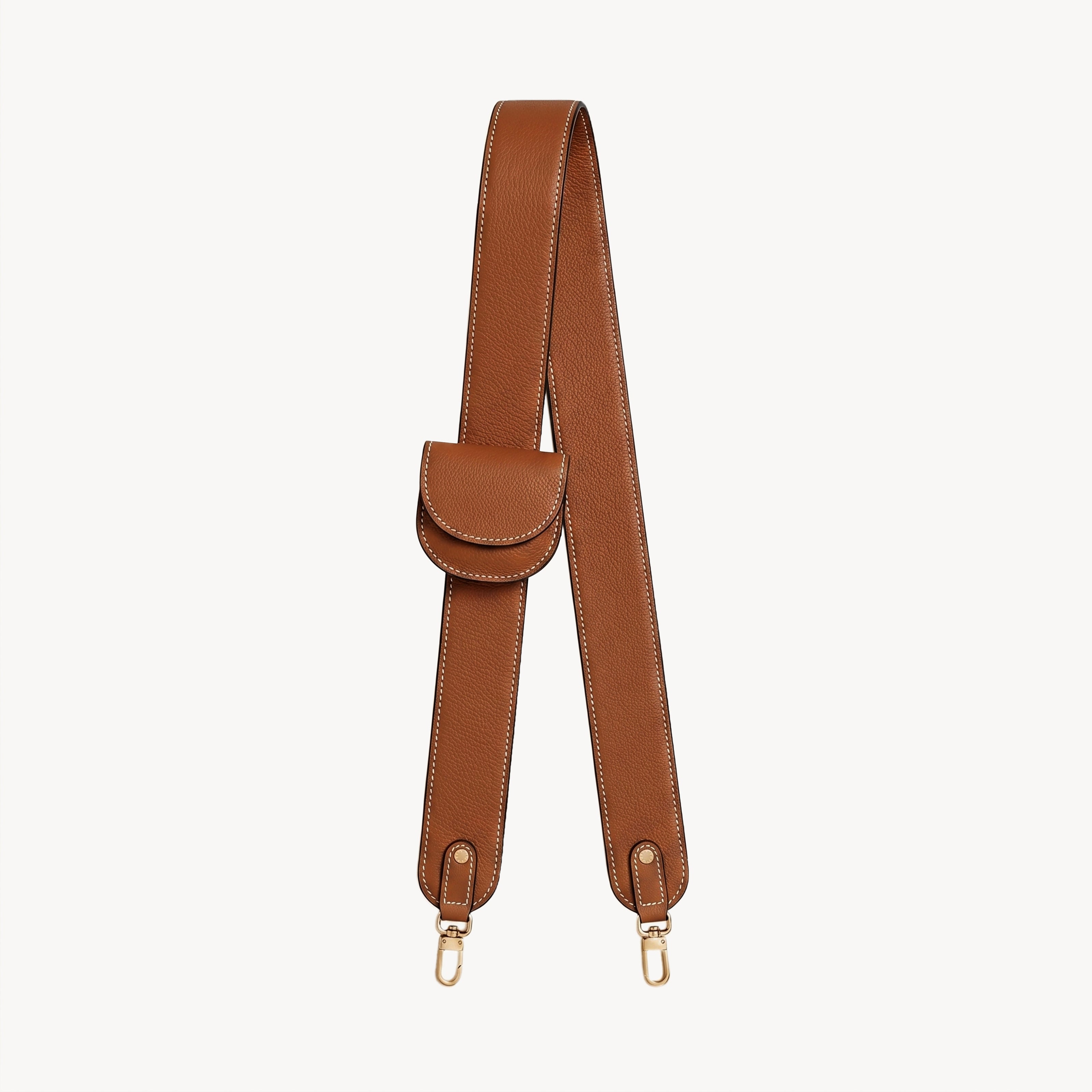 Arvak + Sól bag strap and folding wallet set with a saddle leather finish, featuring adjustable strap and compact wallet design.
