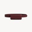 Arvak + Sól burgundy belt bag with mini flap design, featuring a sleek, compact style and adjustable strap.