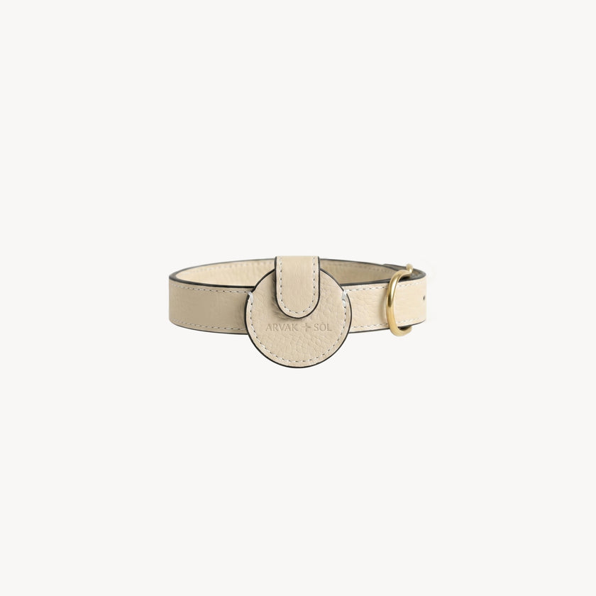 Cream leather Not Your Classic Collar Airtag case by Arvak + Sól, designed to hold and protect your AirTag.
