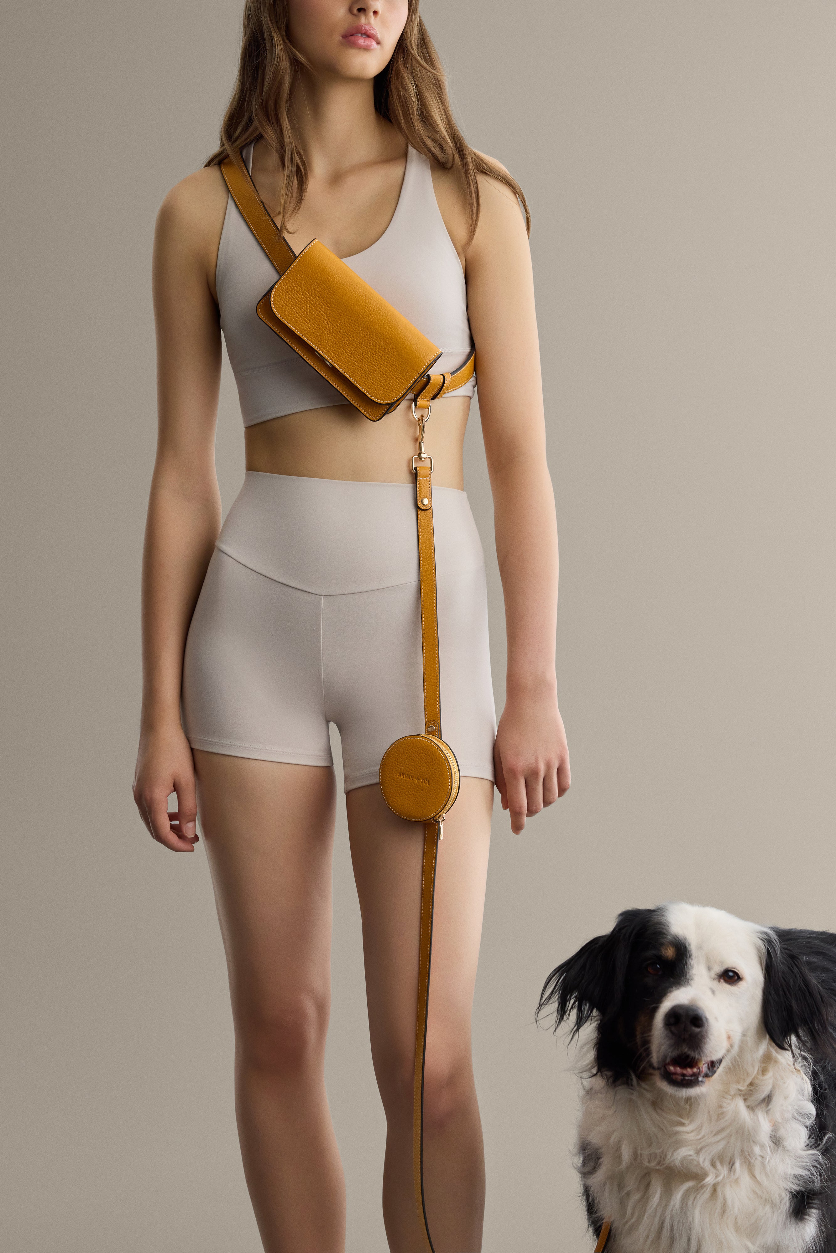 Black leather belt bag by Arvak + Sól, featuring adjustable strap and compact design, shown worn around the waist.
