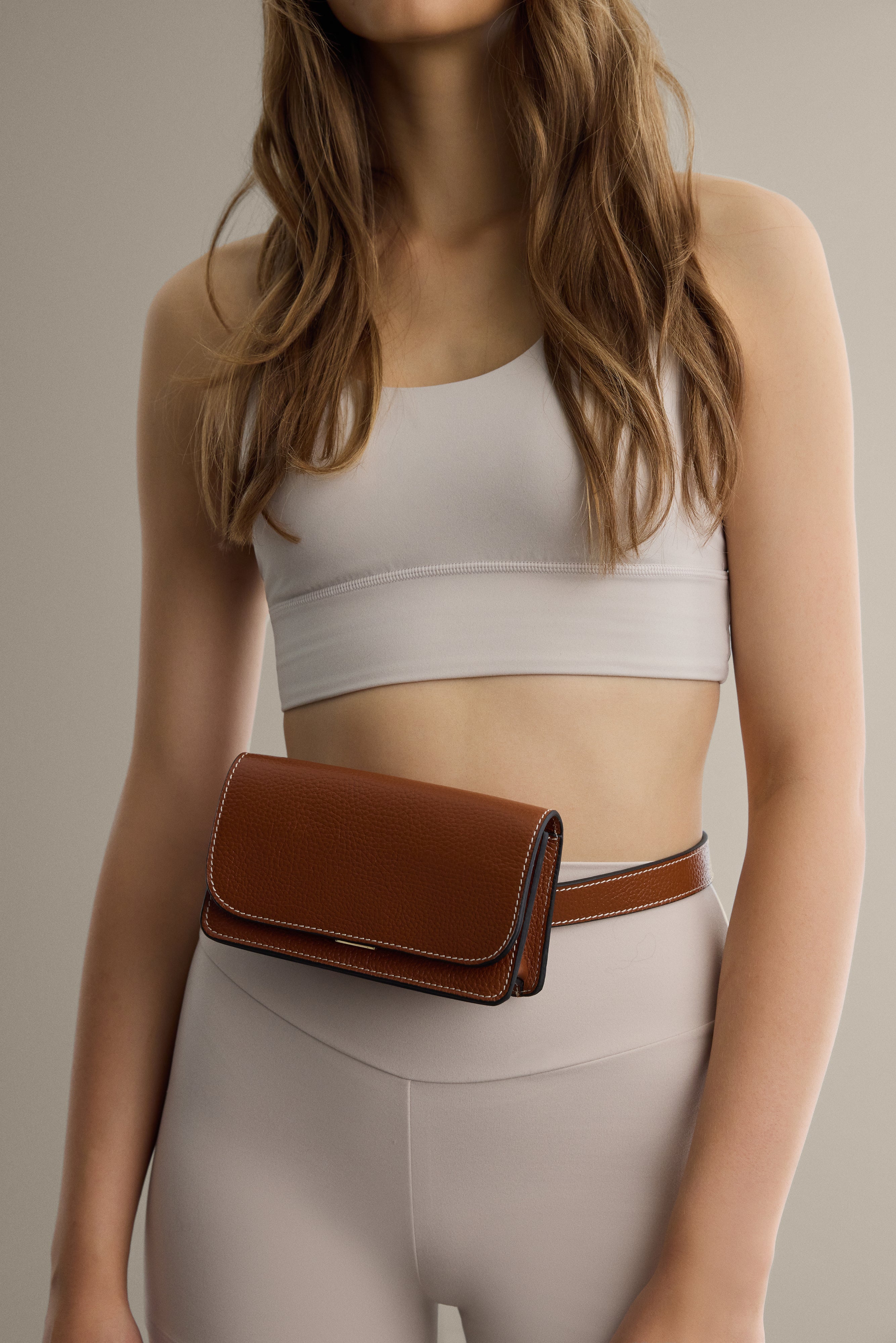 Black leather belt bag from Arvak + Sól featuring a sleek design with adjustable strap and subtle branding.