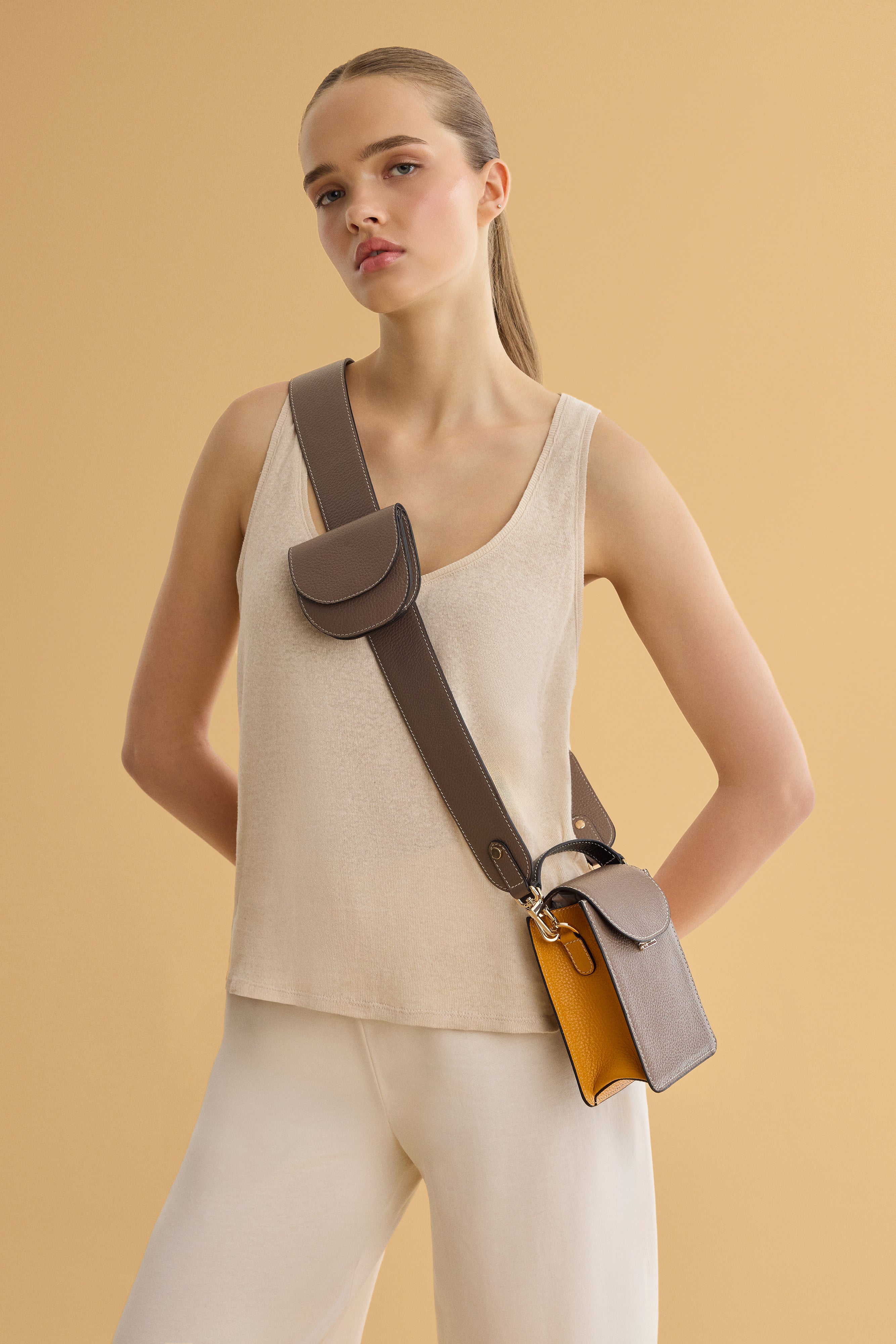 Arvak + Sól bag strap and folding wallet featuring leather and fabric accents, compact design with adjustable strap and multiple card slots.