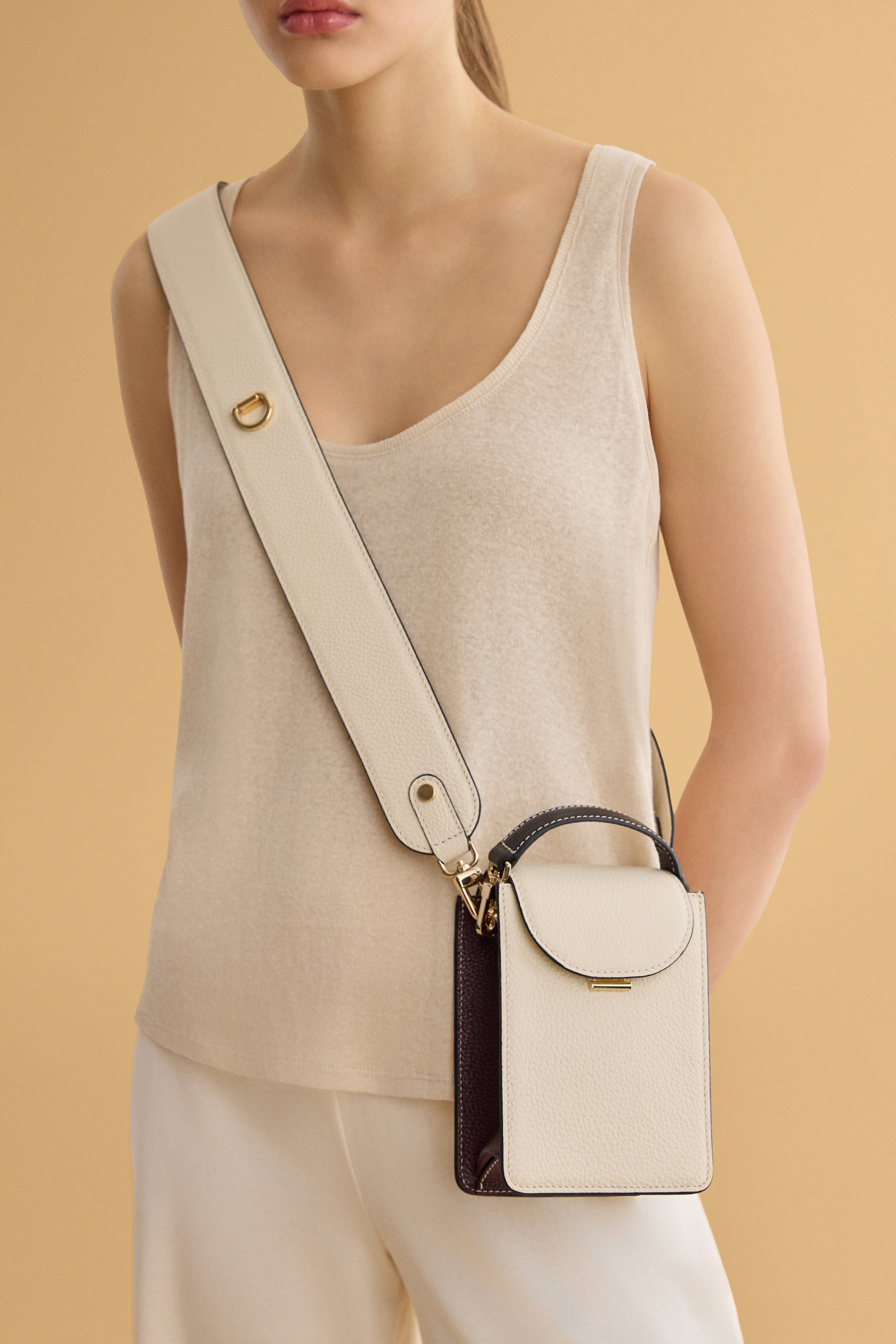 Arvak + Sól micro bag with sleek design, compact size, and minimalist style, featuring a black leather exterior and silver hardware.