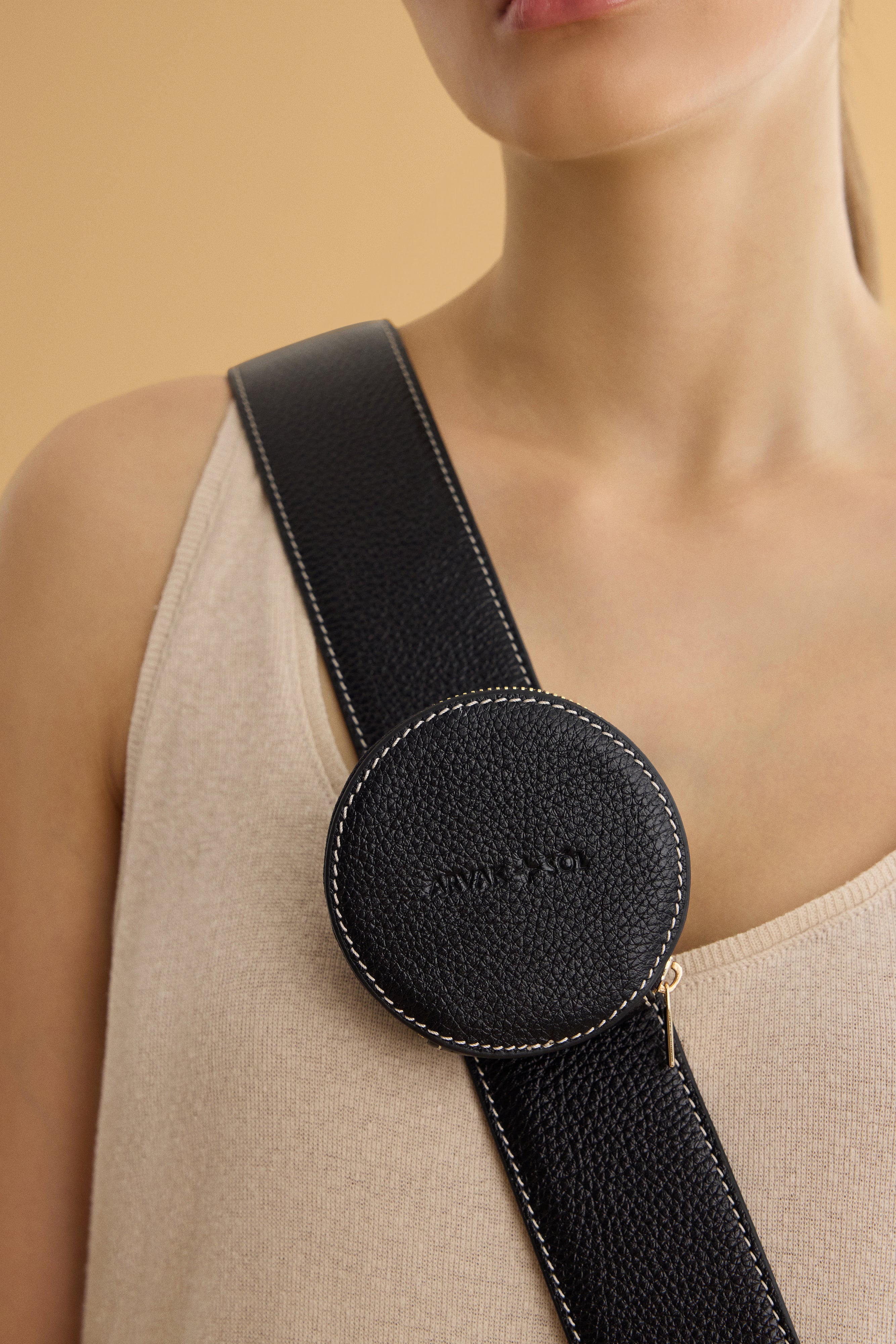 Round waste bag holder by Arvak + Sól, showing a sleek metal design with a circular opening for easy waste bag access.