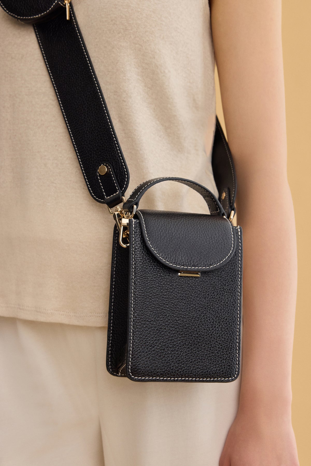 Arvak + Sól micro bag featuring a sleek design with a compact shape and minimalist style, perfect for carrying essentials.
