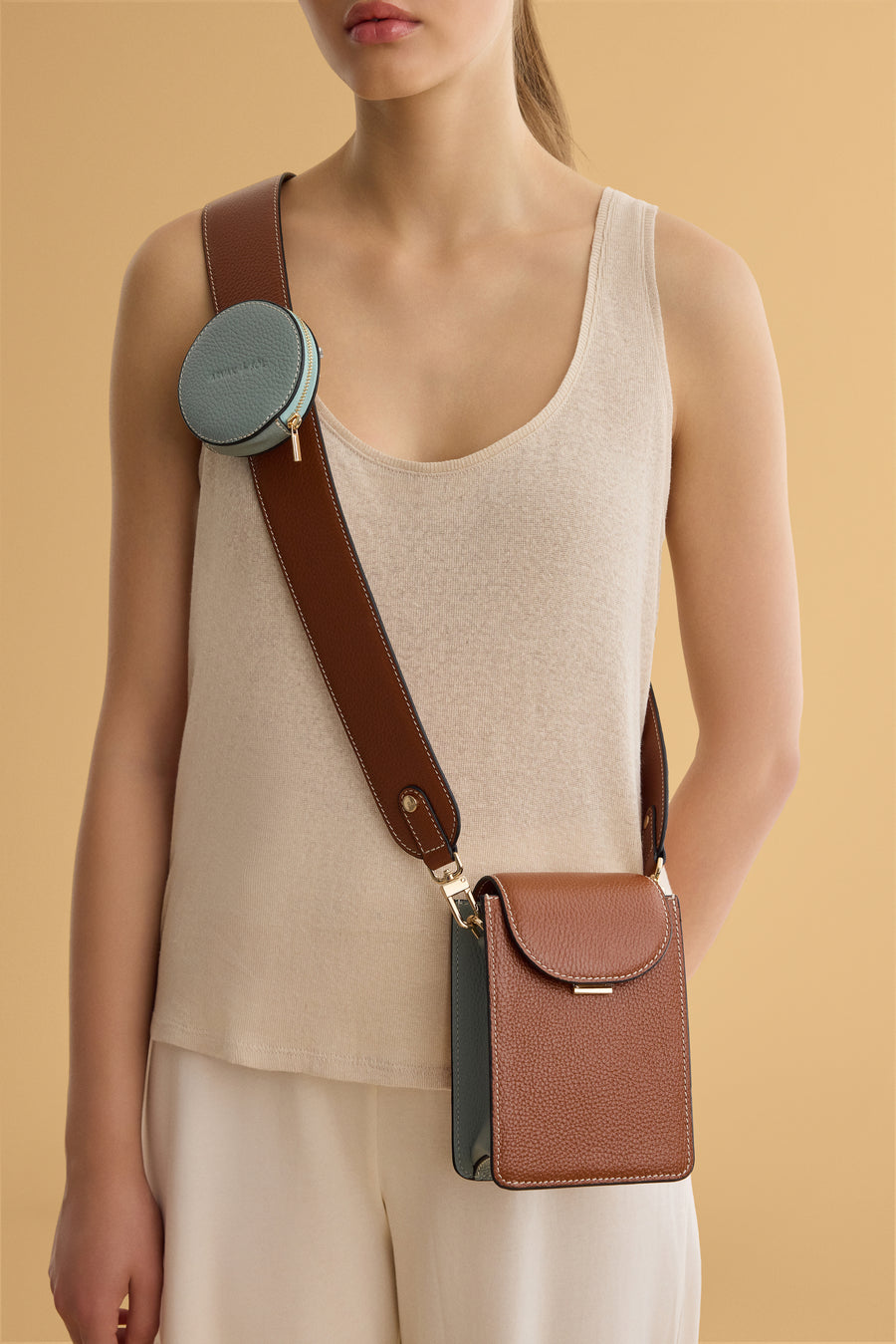 Small Arvak + Sól micro bag with adjustable strap and minimalist design, featuring textured leather and compact size.